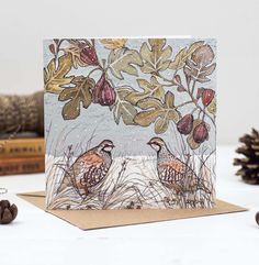 a card with two birds sitting on top of it