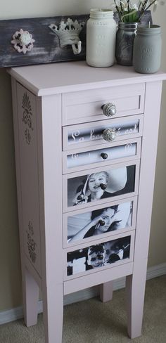 a white dresser with drawers and pictures on it