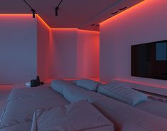 a large white couch sitting under a flat screen tv in a room with red lighting