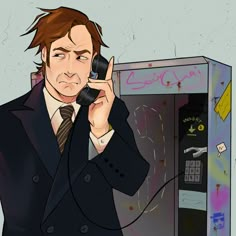 a man in a suit talking on a cell phone next to a vending machine