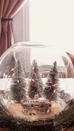 there is a snow globe with trees in it and a bus on the road inside