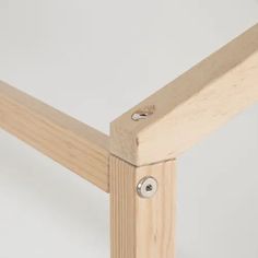 a close up view of a wooden frame with screws on the bottom and sides