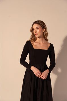 Expertly crafted for timeless elegance, the Galilea Dress in Black features a long sleeve and fitted top for a flattering silhouette. The square neckline adds a touch of sophistication while the full skirt and midi length offer versatile styling options for any occasion. Elevate your wardrobe with this must-have dress. The design process of Kleid is magic! Childhood best friends carefully review each detail to remain truthful to the reasons why they decided to embark in the adventure of reinvent Black Long Sleeve Dress Midi, Orchestra Black Dress, Black Modest Dress, Magic Childhood, Winter Black Dress, Modest Graduation Dress, Black Dress Modest, Childhood Best Friends, Graduation Gown