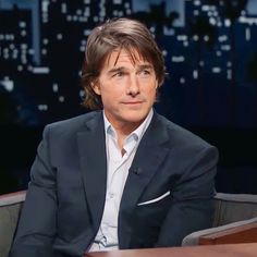 a man in a suit sitting at a table