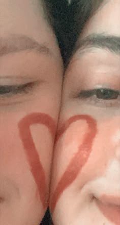 two people with numbers painted on their faces