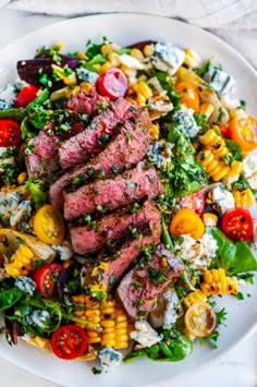 steak and corn salad on a white plate