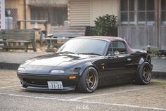 a black sports car parked in front of a building