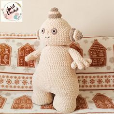 a crocheted stuffed animal sitting on top of a couch