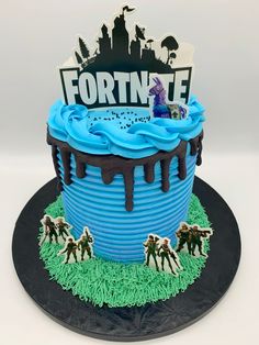 a birthday cake is decorated with blue icing and frosting, including an image of fortnite