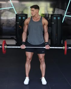 man standing in the gym holding a barbell weight wearing a grey tank top and shorts Male Gym Outfit, Gym Outfit Men Style, Houndstooth Skirt Outfit, Gym Workout Aesthetic, Mens Gym Style, Men Gym Outfit, Gym Fits Men, Training Outfit Men, Mens Gym Wear