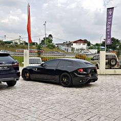 two black sports cars parked next to each other