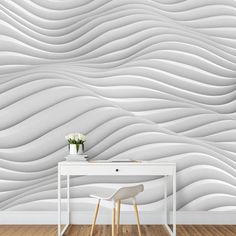 a white table and chair in front of a wall with wavy lines on it,