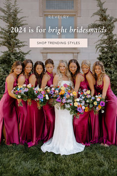 a group of bridesmaids standing in front of a building