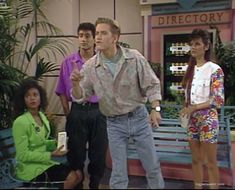 a man standing in front of a group of people on a tv set with the caption directory