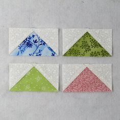 four small pieces of paper with different designs on them