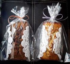 two bags filled with pastries sitting on top of a black table next to each other