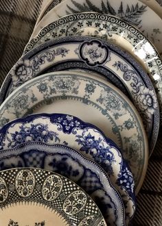 a stack of blue and white plates sitting next to each other