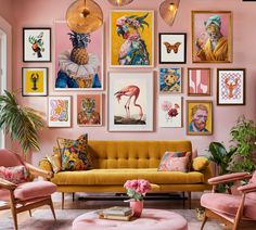 a living room filled with lots of pink furniture and pictures on the wall above it