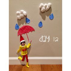 a child's costume made to look like an elf with umbrella and raindrops