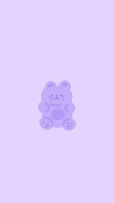 a purple teddy bear sitting on top of a pink wall