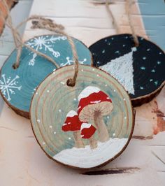 three wooden ornaments with designs on them