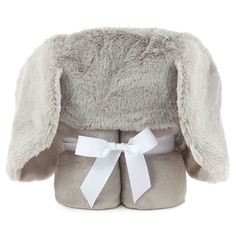 a stuffed animal with a bow on it's head is wearing a gray coat