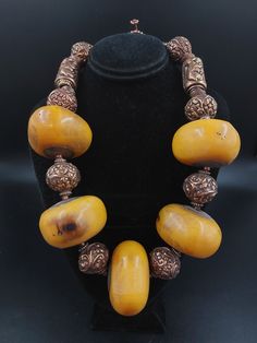 "Up for sale is a unique handmade Necklace comprised of huge Vintage Tibetan Mock-Amber Beads, \"Precious Art Resin\" Beads, Tibetan Repousse Copper Round and Barrel Beads and African Bronze Ring Beads. Beads are made of Phenolic Resin and were known as African Amber or Copal Amber. Many African Trade Beads have traveled the world. Approximate Length: 22-1/2\" Approx. Amber Bead Size: 48mm Diameter x 31-33mm Length Approx. Copper Barrel Bead Size: 37mm Length x 22mm Diameter Approx. Copper Round Amber Jewelry Vintage, Shoes Essential, African Trade Bead Jewelry, Bone Bead Necklace, Loveland Colorado, Art Shoes, Tibetan Jewelry, Beaded Necklace Designs, African Trade Beads