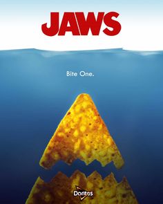 the poster for jaws, which is written in red and yellow on top of an orange triangle