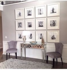 two chairs and a table with pictures on the wall