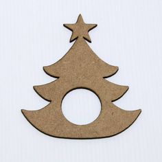 a wooden christmas tree ornament with a star on it's top and a hole in the middle