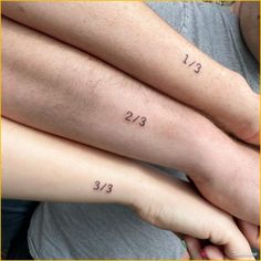 two people with tattoos on their arms and the numbers 13 - 23 tattooed on them