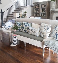 a living room filled with lots of furniture and decor on top of a hard wood floor