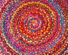 a multicolored rug is shown in the middle of this photo, with many different colored circles on it