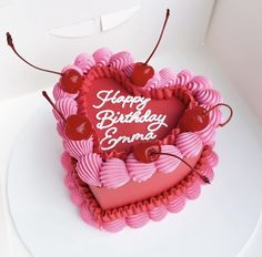 a heart shaped birthday cake on a white plate