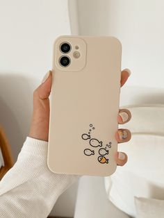 a person holding up a phone case with mickey mouse on it