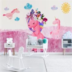 a child's room decorated in pink and white with an unicorn wall decal