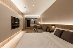 a large bed sitting in a bedroom next to a tv on top of a wooden wall