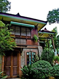 an old building with plants and trees around it