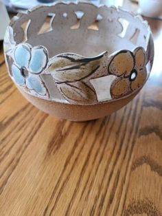 a ceramic bowl sitting on top of a wooden table