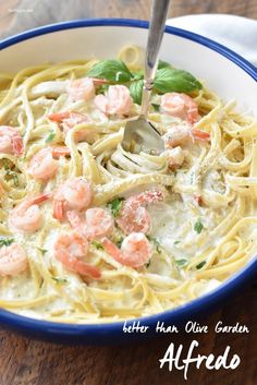 a bowl of pasta with shrimp and basil