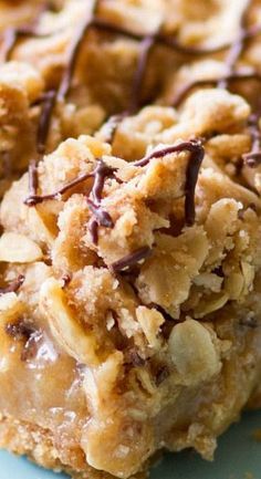 a close up of a piece of food on a plate with chocolate drizzle