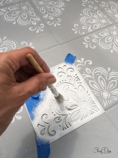 someone is using a paint brush to create a stencil design