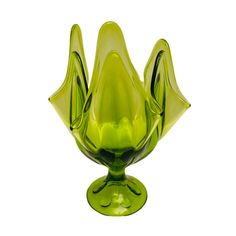 a green glass vase sitting on top of a table