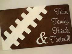 a football themed sign is hanging on the wall