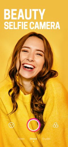 a woman smiling and wearing a yellow sweater with the words beauty selfie camera on it