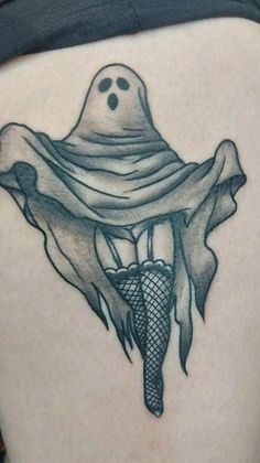 a woman's thigh with a ghost on it and fish net in the belly