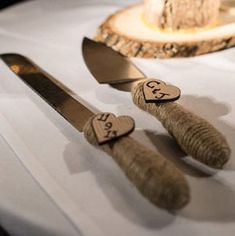 two knives with hearts on them are sitting on a table next to a knife and fork