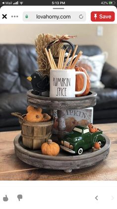 a coffee cup sitting on top of a wooden tray filled with pumpkins and corn