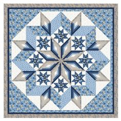 a blue and white quilt with an intricate star design on it's center piece