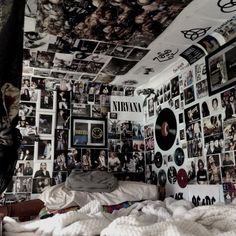 a bedroom with many pictures on the wall